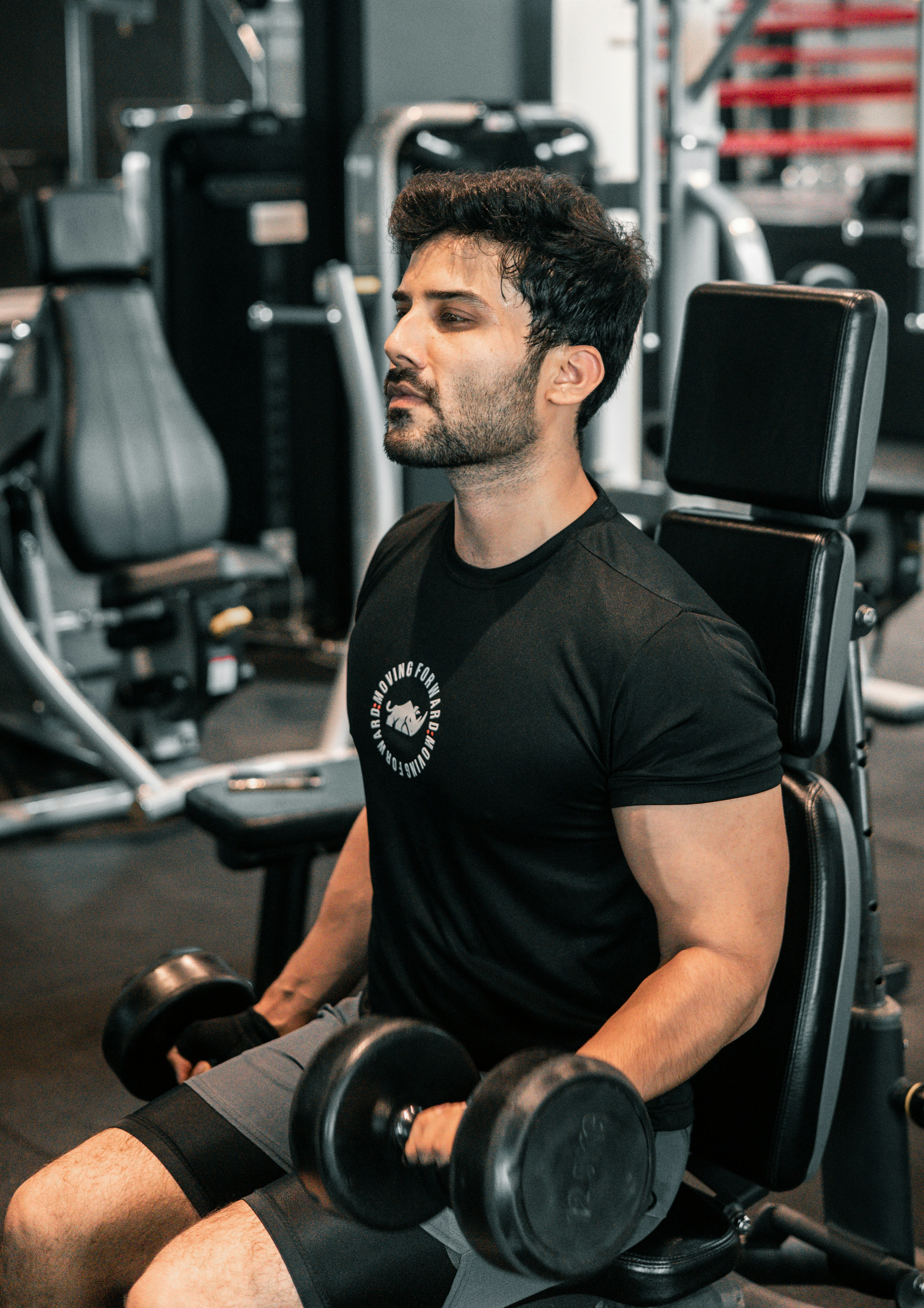 Man training back and biceps with dumbbells